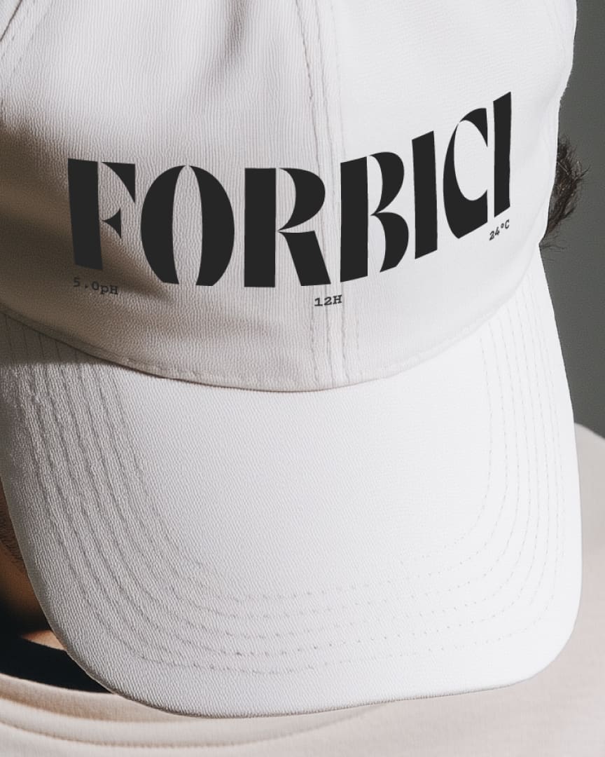 A close-up of a white baseball cap with the word "FORBICI" printed in large, bold black letters on the front. Small text beneath reads "5.OPH 12H 24°C".