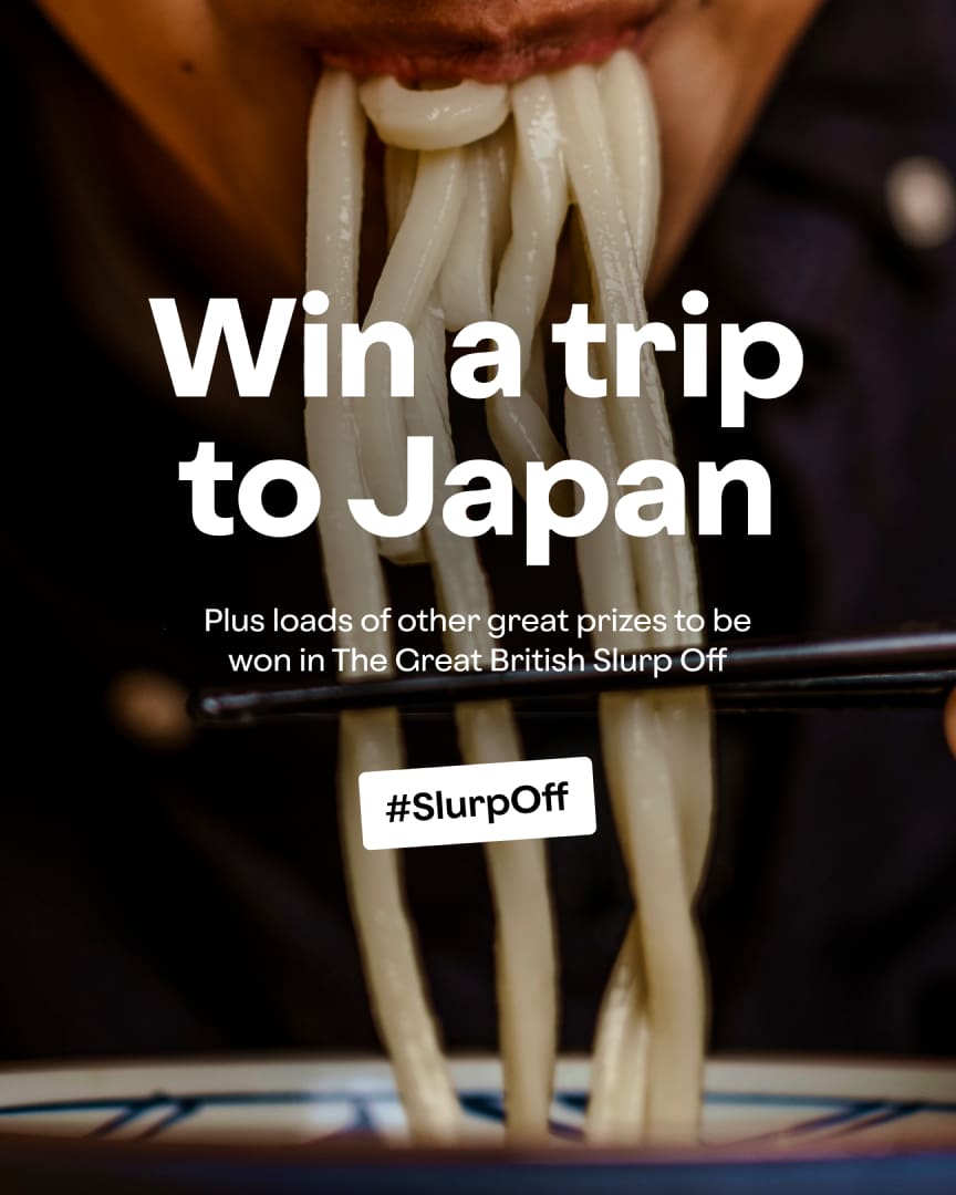 Close-up of a person eating thick noodles with chopsticks, with overlaid text reading "Win a trip to Japan" and "#SlurpOff" promoting a contest called The Great British Slurp Off.