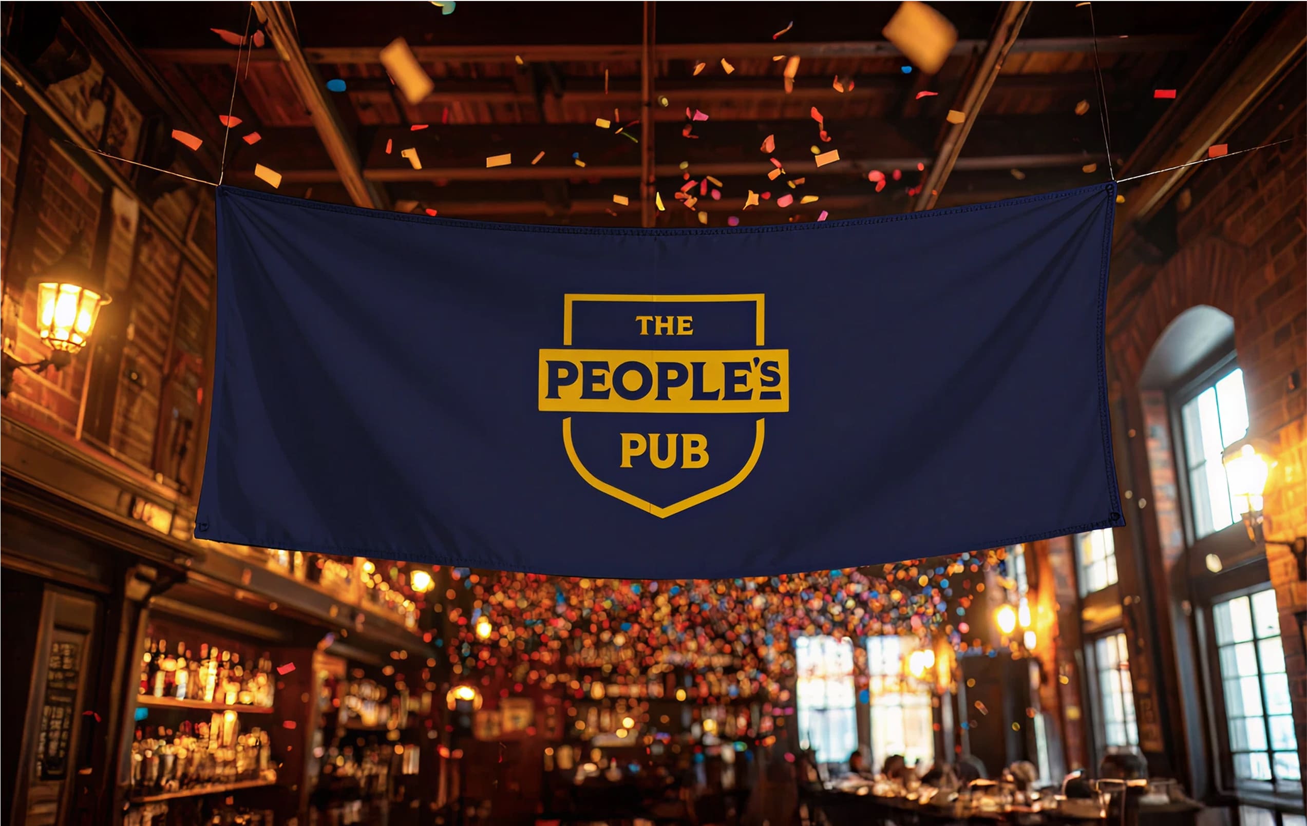 A navy blue banner with the yellow words "The People's Pub" hangs inside a warmly lit pub, with confetti falling above and colorful lights decorating the background.