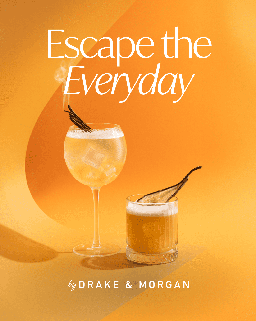 Two cocktails on an orange surface with vanilla garnishes and smoke rising from one. Text above reads, "Escape the Everyday by Drake & Morgan" in white lettering.