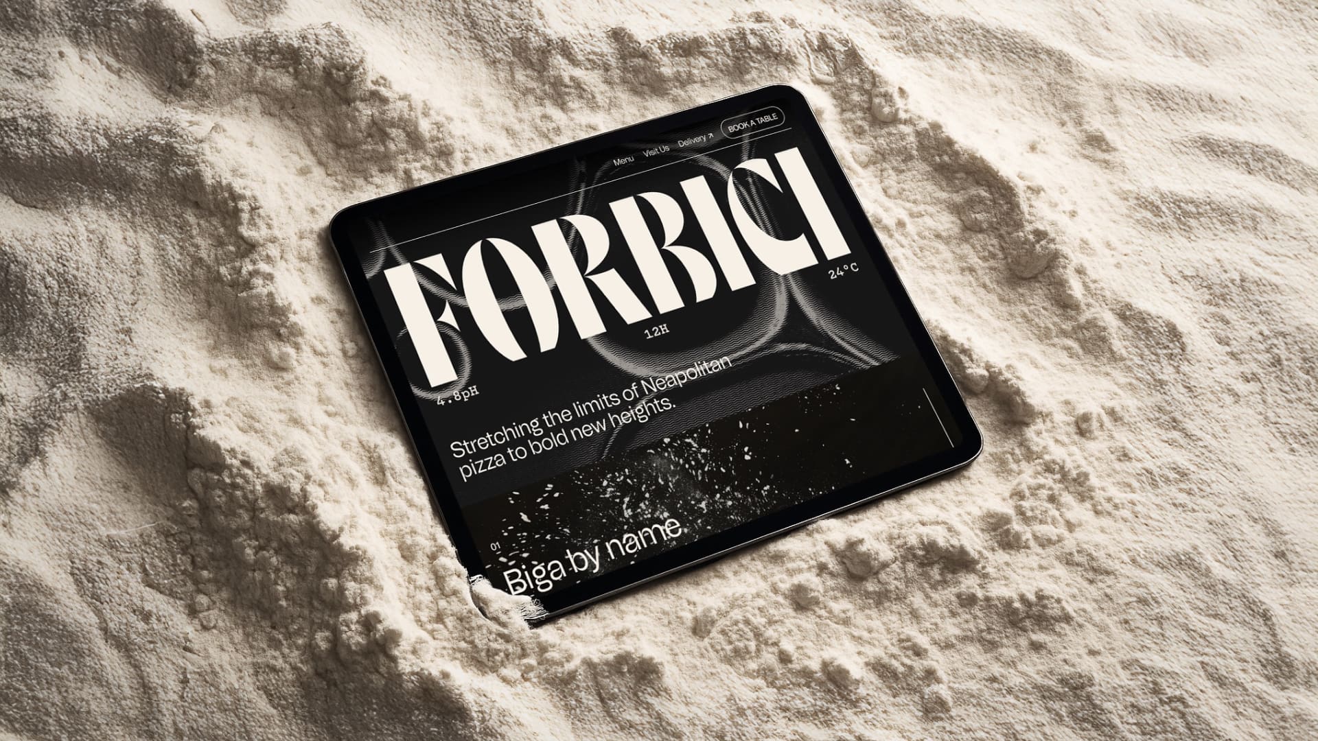 A tablet partially embedded in flour displays a website with the bold word "FORBICI" at the top and smaller text below, all set against a dark background with flour scattered on the screen.