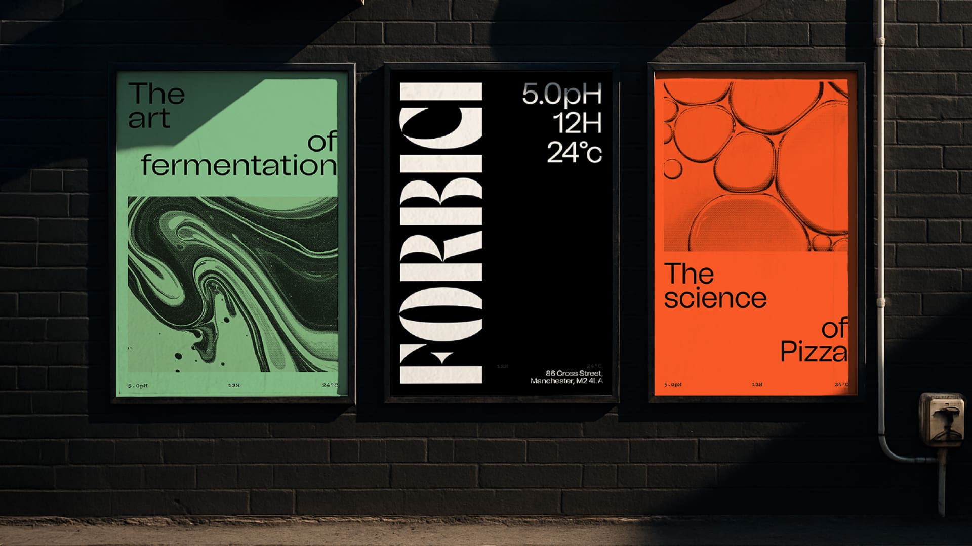 Three posters on a dark brick wall: one green about fermentation with abstract swirls, one black with bold “FORBICI” and fermentation data, and one orange about the science of pizza with bubble patterns.